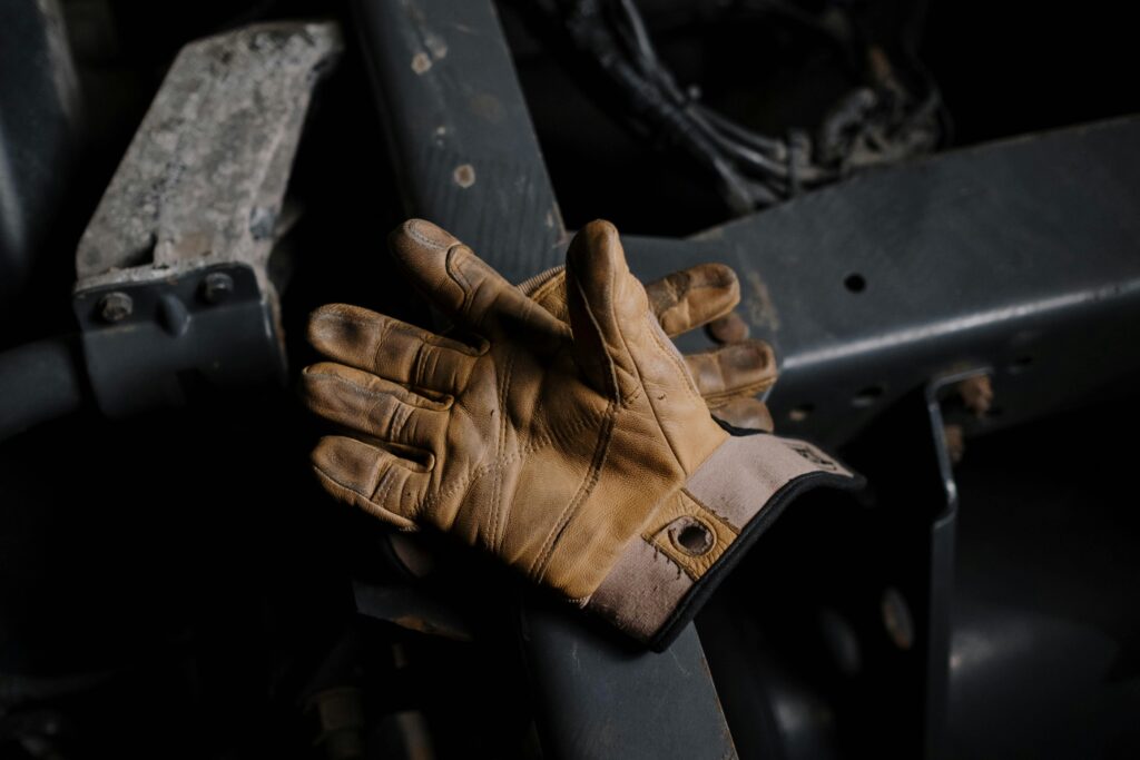 Leather work gloves resting on industrial equipment